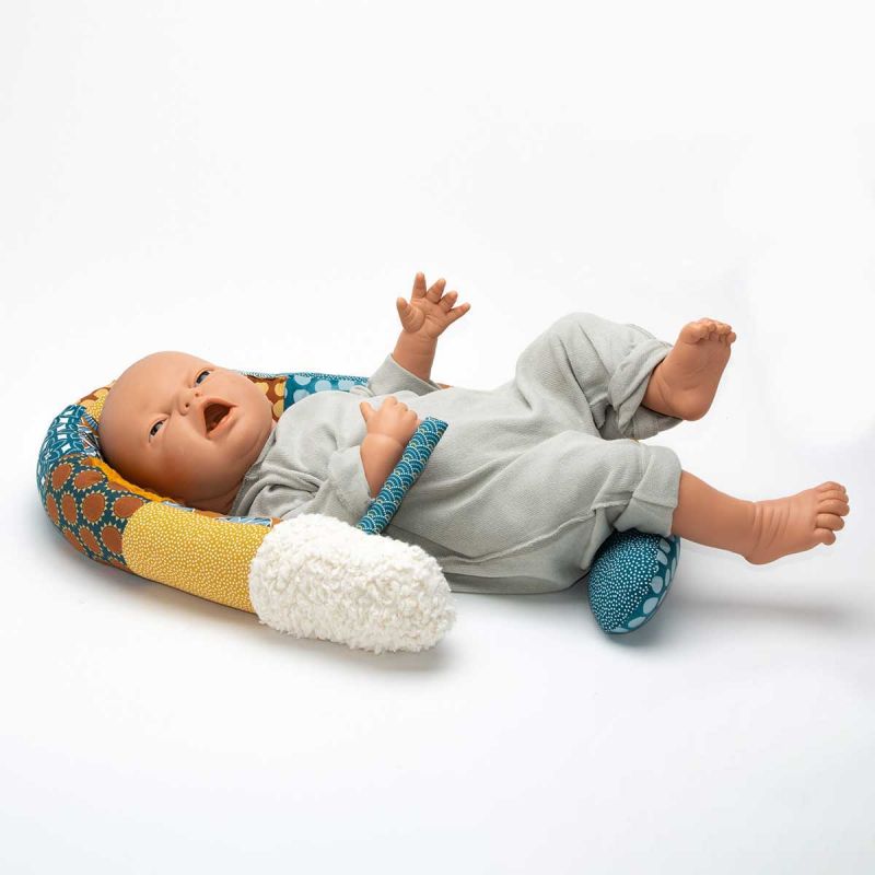 a baby doll in a baby bed